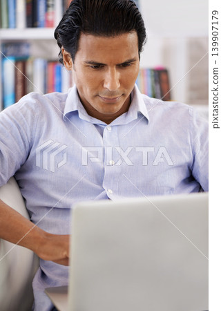 Businessman, laptop and reading on sofa in home for remote work, research and online planning in living room. Entrepreneur, person and technology with corporate project, communication and web surfing Businessman, laptop and reading on sofa in home for remote work, research and online planning in living room. Entrepreneur, person and technology with corporate project, communication and web surfing 139907179