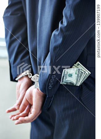Business person, hands and cash with handcuffs for bribe, secret or corruption in financial crime. Closeup or rear view of employee with pocket money, paper or laundering finance in bribery or fraud Business person, hands and cash with handcuffs for bribe, secret or corruption in financial crime. Closeup or rear view of employee with pocket money, paper or laundering finance in bribery or fraud 139907199