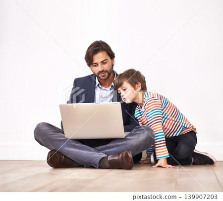 Father, child and laptop on floor for learning, online education and teaching boy at home. Kid, dad and computer for internet, studying and family reading information on technology for communication Father, child and laptop on floor for learning, online education and teaching boy at home. Kid, dad and computer for internet, studying and family reading information on technology for communication 139907203