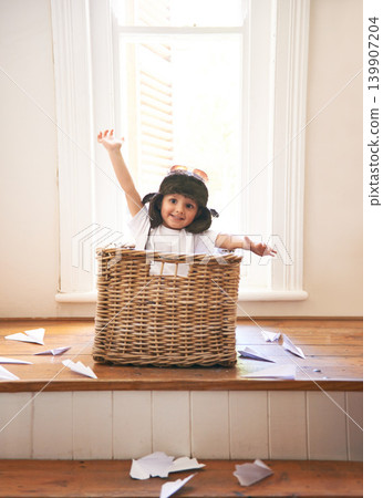 Flying, playing and child with paper plane fantasy and imagination with fun in basket in home. Adventure, little pilot and playful boy in box with future dream, growth and development with airplane Flying, playing and child with paper plane fantasy and imagination with fun in basket in home. Adventure, little pilot and playful boy in box with future dream, growth and development with airplane 139907204