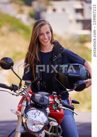 Portrait, smile and outdoor with woman, motorbike and extreme sports with helmet and safety. Face, person and girl with transport and travel with adventure and journey with rider, joyful or road trip 139907213