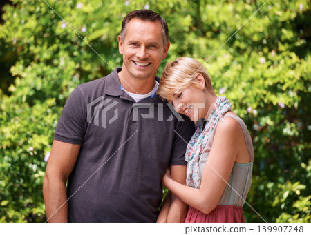 Love, hug and happy couple in a park for travel, adventure and bonding in nature together. Smile, romance and people embrace in a forest for summer date, reunion or weekend, holiday or fun vacation 139907248