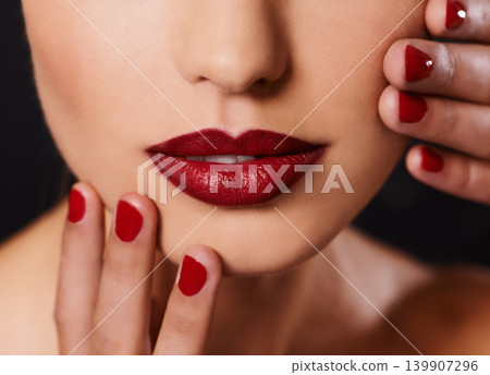 Beauty, cosmetics and mouth of woman with manicure, studio and lipstick with creative aesthetic. Luxury makeup, face and hands with red nail polish for self care, shine and model on black background Beauty, cosmetics and mouth of woman with manicure, studio and lipstick with creative aesthetic. Luxury makeup, face and hands with red nail polish for self care, shine and model on black background 139907296