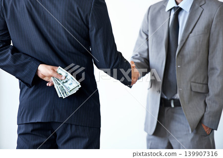 Handshake, deal with corruption and business people in meeting, illegal partnership and fraud with money laundering. Agreement, collaboration and payment for crime with bribery on white background 139907316