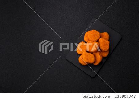 Fried chicken nuggets with sauce, salt, and spices, fast food, unhealthy food. Chicken nuggets Fried chicken nuggets with sauce, salt, and spices, fast food, unhealthy food. Chicken nuggets 139907348