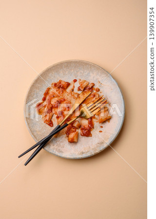 A dirty plate after a meal with leftover pasta and tomato sauce, cleaning. An empty dirty plate A dirty plate after a meal with leftover pasta and tomato sauce, cleaning. An empty dirty plate 139907354