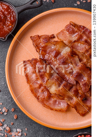 Fried fresh bacon slices with layers of meat or prosciutto with salt and spices. Fried bacon Fried fresh bacon slices with layers of meat or prosciutto with salt and spices. Fried bacon 139907430