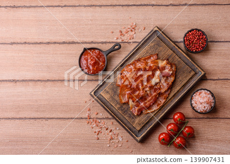Fried fresh bacon slices with layers of meat or prosciutto with salt and spices. Fried bacon Fried fresh bacon slices with layers of meat or prosciutto with salt and spices. Fried bacon 139907431