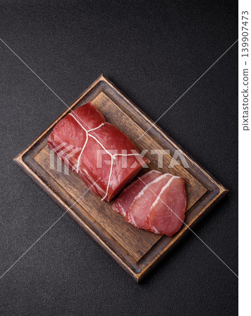 Smoked or dry cured meat slices, pork or ham with salt and spices. Smoked meat slices Smoked or dry cured meat slices, pork or ham with salt and spices. Smoked meat slices 139907473