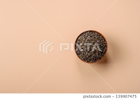 Granules of dried organic Chinese green tea with herbal additives. Dry green tea Granules of dried organic Chinese green tea with herbal additives. Dry green tea 139907475