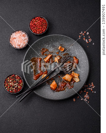 A dirty plate after a meal with leftover pasta and tomato sauce, cleaning. An empty dirty plate A dirty plate after a meal with leftover pasta and tomato sauce, cleaning. An empty dirty plate 139907491