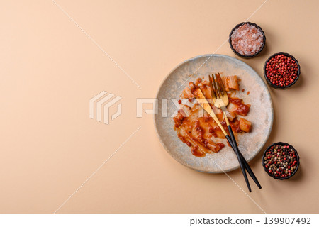 A dirty plate after a meal with leftover pasta and tomato sauce, cleaning. An empty dirty plate A dirty plate after a meal with leftover pasta and tomato sauce, cleaning. An empty dirty plate 139907492