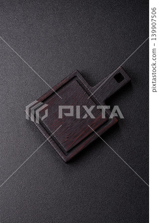 An empty wooden cutting board, kitchen utensils for food preparation. An empty cutting board 139907506