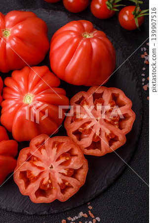 Fresh pink heirloom ribbed tomatoes as an ingredient for a lunch salad. Ribbed heirloom tomatoes Fresh pink heirloom ribbed tomatoes as an ingredient for a lunch salad. Ribbed heirloom tomatoes 139907516