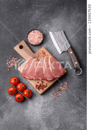 Smoked or dry cured meat slices, pork or ham with salt and spices. Smoked meat slices Smoked or dry cured meat slices, pork or ham with salt and spices. Smoked meat slices 139907630