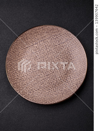 An empty ceramic round plate, kitchen utensils for a dinner table. An empty plate An empty ceramic round plate, kitchen utensils for a dinner table. An empty plate 139907642