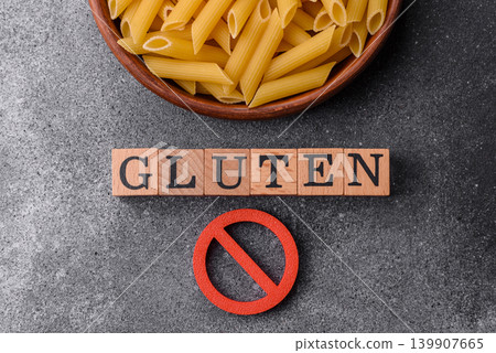 Italian uncooked dry penne regatta pasta with a gluten prohibition sign. The gluten prohibition sign Italian uncooked dry penne regatta pasta with a gluten prohibition sign. The gluten prohibition sign 139907665