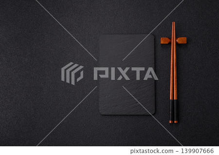 Empty slate board with wooden chopsticks for Asian food. Empty slate board Empty slate board with wooden chopsticks for Asian food. Empty slate board 139907666