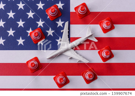 A mock up of airplane with no fly signs on a US flag as a concept for a flight ban A mock up of airplane with no fly signs on a US flag as a concept for a flight ban 139907674