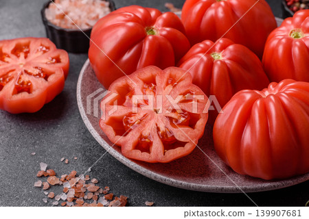 Fresh pink heirloom ribbed tomatoes as an ingredient for a lunch salad. Ribbed heirloom tomatoes Fresh pink heirloom ribbed tomatoes as an ingredient for a lunch salad. Ribbed heirloom tomatoes 139907681