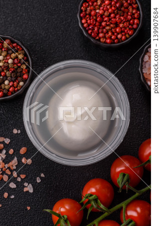Fresh white burrata cheese with tomatoes for a salad. Burrata cheese Fresh white burrata cheese with tomatoes for a salad. Burrata cheese 139907684