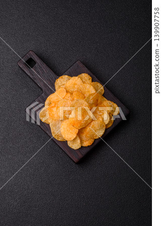 Crispy potato chips, golden slices seasoned with salt and spices. Potato chips 139907758