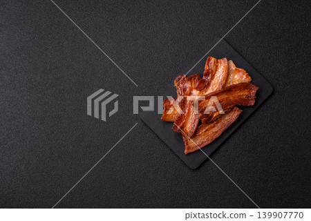 Fried fresh bacon slices with layers of meat or prosciutto prepared for breakfast. Fried bacon Fried fresh bacon slices with layers of meat or prosciutto prepared for breakfast. Fried bacon 139907770
