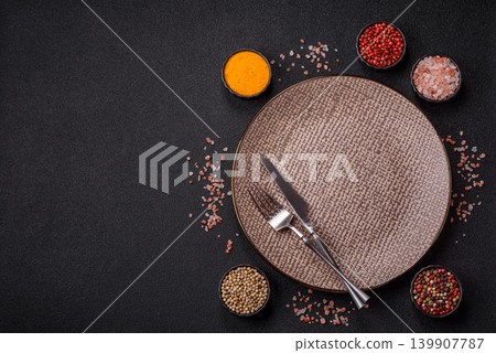 An empty ceramic round plate, kitchen utensils for a dinner table. An empty plate An empty ceramic round plate, kitchen utensils for a dinner table. An empty plate 139907787