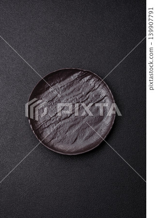 An empty ceramic round plate, kitchen utensils for a dinner table. An empty plate 139907791