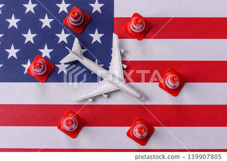 A mock up of airplane with no fly signs on a US flag as a concept for a flight ban A mock up of airplane with no fly signs on a US flag as a concept for a flight ban 139907805
