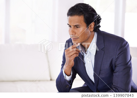 Thinking, brainstorming and business man on a sofa with remote work, ideas or freelance startup inspiration at home. Worker, problem solving or male entrepreneur in a living room planning career goal Thinking, brainstorming and business man on a sofa with remote work, ideas or freelance startup inspiration at home. Worker, problem solving or male entrepreneur in a living room planning career goal 139907843