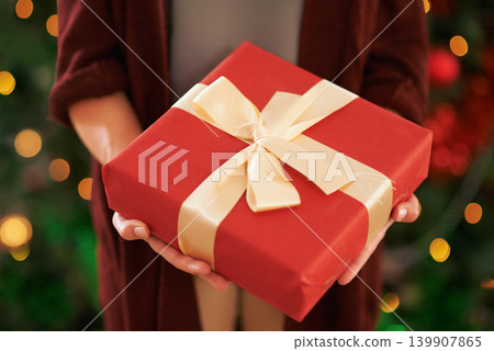 Hands, gift and Christmas box for festive season on holiday or present package for celebrate, party or decoration. Person, fingers and giving in Canada with ribbon or joyful vacation, bokeh or lights Hands, gift and Christmas box for festive season on holiday or present package for celebrate, party or decoration. Person, fingers and giving in Canada with ribbon or joyful vacation, bokeh or lights 139907865