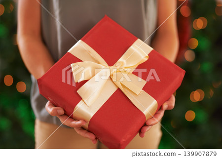Person, gift and Christmas box for festive season on holiday or present package for celebrate, party or decoration. Hands, fingers and giving in Canada with ribbon or joyful vacation, bokeh or lights Person, gift and Christmas box for festive season on holiday or present package for celebrate, party or decoration. Hands, fingers and giving in Canada with ribbon or joyful vacation, bokeh or lights 139907879