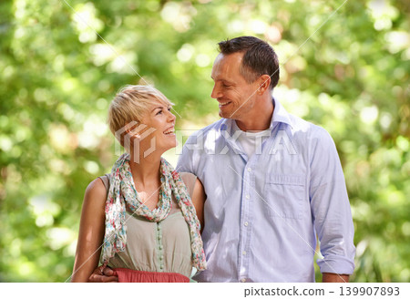 Hug, love and happy couple in a park for travel, adventure and bonding in nature together. Smile, romance and people embrace in a forest for summer date, reunion or weekend, holiday or fun vacation 139907893