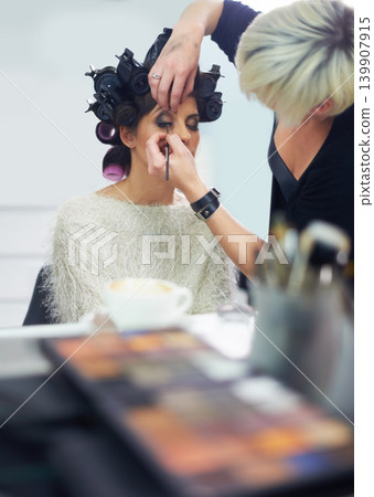 Women, mirror and makeup at hair salon with beauty for cosmetics, skincare and cosmetology with wellness. Model, people and hairdresser or beautician with client for product application and haircare Women, mirror and makeup at hair salon with beauty for cosmetics, skincare and cosmetology with wellness. Model, people and hairdresser or beautician with client for product application and haircare 139907915