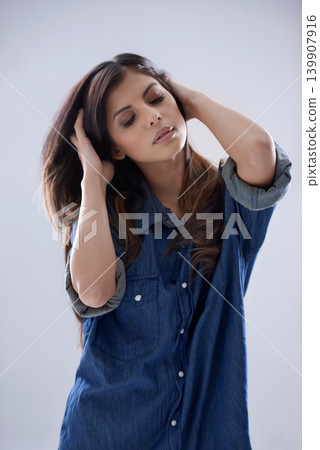 Fashion, denim and woman with confidence in studio in trendy clothes, casual style and cool outfit. Hair, sensual and isolated person with shirt for style, beauty and clothing on gray background Fashion, denim and woman with confidence in studio in trendy clothes, casual style and cool outfit. Hair, sensual and isolated person with shirt for style, beauty and clothing on gray background 139907916