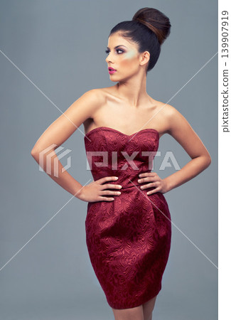 Fashion, makeup and woman in studio with dress for elegant, trendy and classy outfit for beauty. Cosmetics, confident and beautiful young female model with fancy style isolated by gray background. Fashion, makeup and woman in studio with dress for elegant, trendy and classy outfit for beauty. Cosmetics, confident and beautiful young female model with fancy style isolated by gray background. 139907919