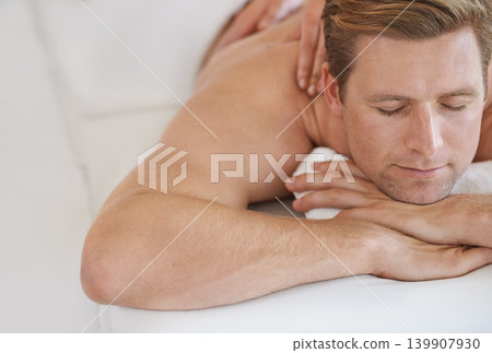 Hands, back massage and man at spa to relax, peace and calm at luxury resort for wellness. Service, therapy or person at salon to pamper body, skincare or beauty treatment for health with eyes closed Hands, back massage and man at spa to relax, peace and calm at luxury resort for wellness. Service, therapy or person at salon to pamper body, skincare or beauty treatment for health with eyes closed 139907930