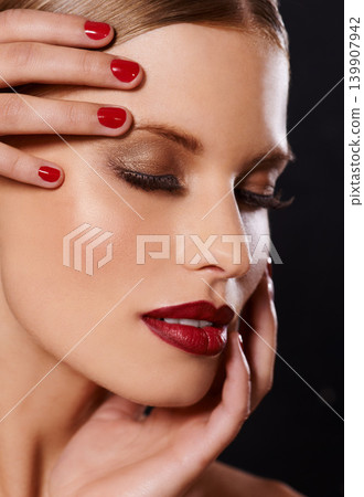 Face, makeup and woman for beauty, hand for manicure and red nail polish, lipstick and eyeshadow with lashes on black background. Skin, foundation and shine, color for cosmetics and glamour in studio Face, makeup and woman for beauty, hand for manicure and red nail polish, lipstick and eyeshadow with lashes on black background. Skin, foundation and shine, color for cosmetics and glamour in studio 139907942