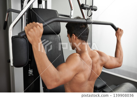 Fitness, shoulder press and back of man in studio on gray background for training or workout at gym. Exercise, health or pull down machine and body builder with equipment for wellness or strength 139908036