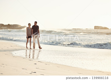 Couple, talking and beach at sunset for romantic date, weekend getaway or vacation in Indonesia. Happy woman, man or people in love with smile for evening walk, bonding and relaxation by shore Couple, talking and beach at sunset for romantic date, weekend getaway or vacation in Indonesia. Happy woman, man or people in love with smile for evening walk, bonding and relaxation by shore 139908118
