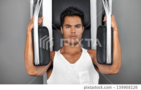 Exercise machine, portrait and man with fitness, strong and strength training with challenge and endurance. Face, bodybuilder and person in a wellness center and workout with progress and healthy Exercise machine, portrait and man with fitness, strong and strength training with challenge and endurance. Face, bodybuilder and person in a wellness center and workout with progress and healthy 139908126