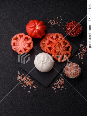 Fresh white burrata cheese with tomatoes for a salad. Burrata cheese Fresh white burrata cheese with tomatoes for a salad. Burrata cheese 139908180