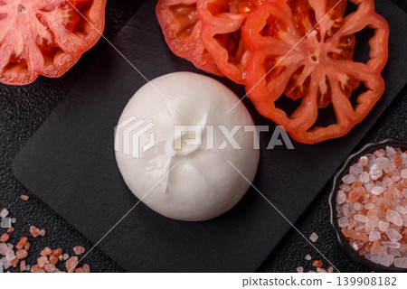 Fresh white burrata cheese with tomatoes for a salad. Burrata cheese Fresh white burrata cheese with tomatoes for a salad. Burrata cheese 139908182