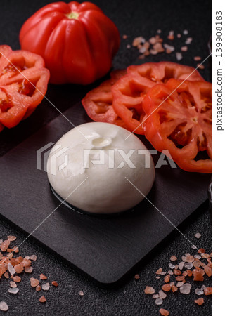 Fresh white burrata cheese with tomatoes for a salad. Burrata cheese Fresh white burrata cheese with tomatoes for a salad. Burrata cheese 139908183