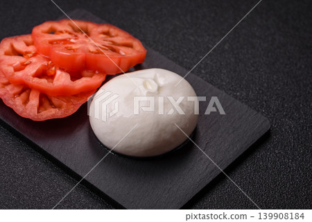 Fresh white burrata cheese with tomatoes for a salad. Burrata cheese Fresh white burrata cheese with tomatoes for a salad. Burrata cheese 139908184