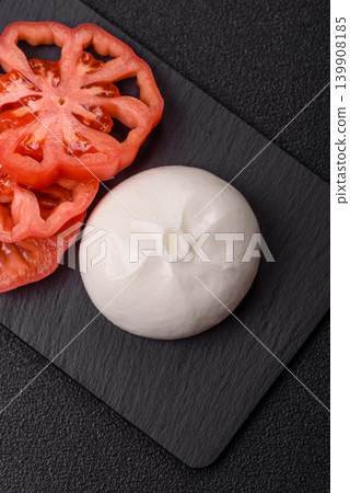 Fresh white burrata cheese with tomatoes for a salad. Burrata cheese Fresh white burrata cheese with tomatoes for a salad. Burrata cheese 139908185