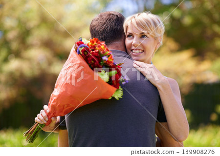 Hug, happy couple and gift of flowers outdoor in nature, bonding and date on valentines day. Bouquet, man and woman embrace with present for love, care and romantic connection at garden together Hug, happy couple and gift of flowers outdoor in nature, bonding and date on valentines day. Bouquet, man and woman embrace with present for love, care and romantic connection at garden together 139908276