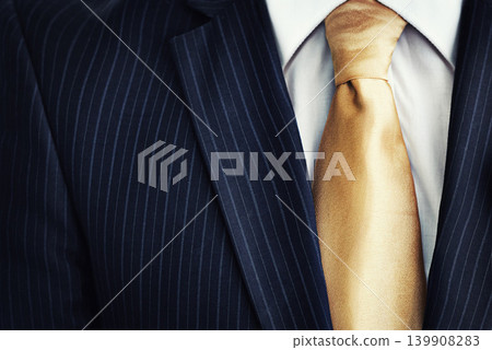 Businessman, suit and gold tie in fashion for corporate style, attire or clothing with jacket, lines or pattern. Closeup of man, worker or employee in stylish shirt of neat professional with necktie Businessman, suit and gold tie in fashion for corporate style, attire or clothing with jacket, lines or pattern. Closeup of man, worker or employee in stylish shirt of neat professional with necktie 139908283