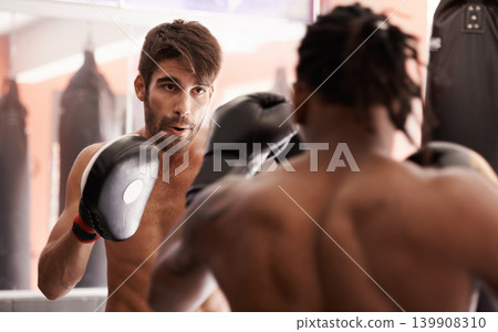 Men, coach and mixed martial arts with punch in fight, gloves and pad for fitness in gym together. People, combat and action for mma, boxing or hands for power, workout and exercise for competition Men, coach and mixed martial arts with punch in fight, gloves and pad for fitness in gym together. People, combat and action for mma, boxing or hands for power, workout and exercise for competition 139908310